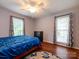 Bright bedroom with hardwood floors, ceiling fan, and large windows at 11120 Sevilla Ct, Charlotte, NC 28226