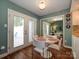 Bright dining area with French doors to a patio, hardwood floors, and access to the kitchen at 11120 Sevilla Ct, Charlotte, NC 28226