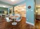 Cozy dining area with hardwood floors, a mirrored wall, and convenient access to the kitchen at 11120 Sevilla Ct, Charlotte, NC 28226