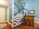 Inviting foyer with hardwood floors, staircase, and decorative bar area at 11120 Sevilla Ct, Charlotte, NC 28226