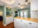 Open kitchen featuring white cabinetry, wood countertops, and eat-in bar area at 11120 Sevilla Ct, Charlotte, NC 28226