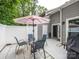 Cozy outdoor patio with seating, a striped umbrella, a grill, and convenient access to the house at 11120 Sevilla Ct, Charlotte, NC 28226