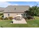 Enjoy the backyard with a patio and patio furniture, well-maintained lawn and landscaping at 112 E Neel Ranch Rd, Mooresville, NC 28115