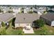 Aerial view of backyard with patio, umbrella and furniture, surrounded by lush landscaping in a lovely community at 112 E Neel Ranch Rd, Mooresville, NC 28115