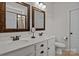 Bathroom with a double vanity, framed mirrors, and tiled shower at 112 E Neel Ranch Rd, Mooresville, NC 28115