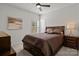 Cozy bedroom with wood bed frame, neutral walls, and natural light at 112 E Neel Ranch Rd, Mooresville, NC 28115