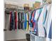 Organized closet with hanging clothes and shelving for storage at 112 E Neel Ranch Rd, Mooresville, NC 28115