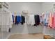 Organized walk-in closet with ample hanging space and hardwood floor at 112 E Neel Ranch Rd, Mooresville, NC 28115