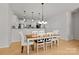 Bright dining room featuring modern lighting, hardwood floors and an adjacent kitchen at 112 E Neel Ranch Rd, Mooresville, NC 28115