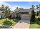 A beautiful single-Gathering home featuring a stone facade, manicured lawn, and a convenient two-car garage at 112 E Neel Ranch Rd, Mooresville, NC 28115