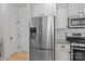 Modern kitchen featuring stainless steel appliances, white cabinetry, and granite countertops at 112 E Neel Ranch Rd, Mooresville, NC 28115