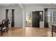 Sunlit living room featuring wood floors, neutral walls, an open doorway and dark trim at 112 E Neel Ranch Rd, Mooresville, NC 28115