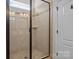 Modern tiled shower with glass enclosure and built-in niche at 112 E Neel Ranch Rd, Mooresville, NC 28115