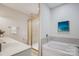 Bathroom featuring a soaking tub and single sink vanity with ample counter space at 11234 Villa Trace Pl, Charlotte, NC 28277