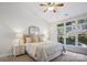 Relaxing bedroom with a large window offering natural light and lush greenery at 11234 Villa Trace Pl, Charlotte, NC 28277