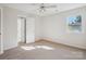 Bright bedroom with carpet, ceiling fan, window, and access to the bathroom at 11234 Villa Trace Pl, Charlotte, NC 28277