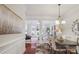 Open-concept dining room leading to living room with white columns, hardwood floors, and modern décor at 11234 Villa Trace Pl, Charlotte, NC 28277