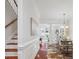 Spacious dining room with hardwood floors, wainscoting, and an open flow to the living room at 11234 Villa Trace Pl, Charlotte, NC 28277
