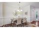 Bright dining area with neutral decor, modern chandelier, hardwood floors and stylish furnishings at 11234 Villa Trace Pl, Charlotte, NC 28277