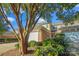 Charming townhouse with brick facade, white garage door, manicured flower garden and mature crape myrtle at 11234 Villa Trace Pl, Charlotte, NC 28277
