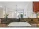 Close up of kitchen sink with dark granite countertop overlooking breakfast nook and outside at 11234 Villa Trace Pl, Charlotte, NC 28277