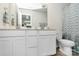 Bathroom featuring double sink vanity, framed mirrors, and tiled floors at 11733 Mesquite Rd, Huntersville, NC 28078