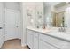 Bathroom with double vanity, framed mirror, white cabinetry, and tile floors at 11733 Mesquite Rd, Huntersville, NC 28078