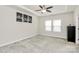 Spacious bedroom with tray ceilings, neutral carpet, and ample natural light from large windows at 11733 Mesquite Rd, Huntersville, NC 28078
