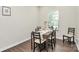 Cozy dining room with a dark wood table, seating for six, and a bright window view at 11733 Mesquite Rd, Huntersville, NC 28078