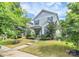 Charming two-story home with blue shutters and a well-manicured front lawn and lush greenery at 11733 Mesquite Rd, Huntersville, NC 28078
