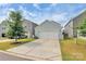 Charming home with a two-car garage, driveway, and inviting curb appeal with landscaped lawn at 11733 Mesquite Rd, Huntersville, NC 28078