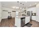 Modern kitchen with stainless steel appliances, white cabinetry, and a center island with pendant lighting at 11733 Mesquite Rd, Huntersville, NC 28078