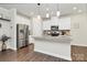 Bright kitchen with white cabinets, stainless steel appliances, and a large island with seating at 11733 Mesquite Rd, Huntersville, NC 28078