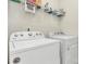 Functional laundry room equipped with a washing machine, dryer, and storage shelves at 11733 Mesquite Rd, Huntersville, NC 28078