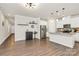 Open-concept living area with stainless steel refrigerator, wood flooring and neutral colors at 11733 Mesquite Rd, Huntersville, NC 28078