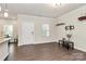 Open floor plan with wood floors seamlessly connecting the kitchen, dining, and living areas at 11733 Mesquite Rd, Huntersville, NC 28078