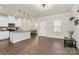 Open floor plan with wood floors seamlessly connecting the kitchen, dining, and living areas at 11733 Mesquite Rd, Huntersville, NC 28078