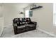 Comfortable loft area with a reclining sofa and floating shelves at 11733 Mesquite Rd, Huntersville, NC 28078