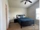 This primary bedroom features a ceiling fan, and a large window providing plenty of natural light at 1177 Triece Ln, Charlotte, NC 28215