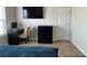 This bedroom features a black desk, a black dresser, and a tv mounted to the wall at 1177 Triece Ln, Charlotte, NC 28215