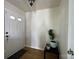 A welcoming entryway featuring a white front door, a black table, a decorative plant, and hardwood floors at 1177 Triece Ln, Charlotte, NC 28215
