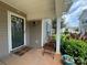 Inviting front porch with a chair and decorative potted plants at 1177 Triece Ln, Charlotte, NC 28215