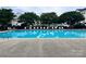 Sparkling community pool surrounded by lounge chairs, lush trees, and manicured landscaping at 1177 Triece Ln, Charlotte, NC 28215
