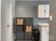 Ample storage solutions with a shelving unit and overhead cabinets at 1177 Triece Ln, Charlotte, NC 28215