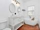 Modern bathroom with dual vanity, soaking tub, and windows at 12300 Caldwell Rd, Charlotte, NC 28213