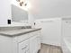 Bathroom featuring a granite vanity with a modern sink and white cabinets with an extra-large rectangular mirror at 12300 Caldwell Rd, Charlotte, NC 28213