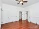 Bright bedroom featuring hardwood floors and two doorways at 12300 Caldwell Rd, Charlotte, NC 28213