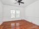Bright bedroom featuring hardwood floors, ceiling fan and windows at 12300 Caldwell Rd, Charlotte, NC 28213