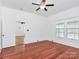 Bright bedroom featuring hardwood floors, ceiling fan and windows at 12300 Caldwell Rd, Charlotte, NC 28213