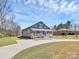 Inviting home with a covered porch and well-maintained lawn at 12300 Caldwell Rd, Charlotte, NC 28213